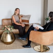 Dr. Karolina LaBrecque taking notes during a one-on-one coaching conversation