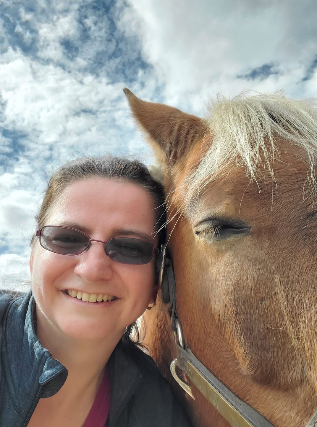 Dr. Karolina LaBrecque outdoors with a horse