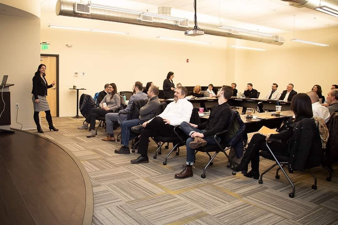 Dr. Karolina LaBrecque speaking to a room during a workshop presentation